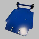 A blue metal wheel assembly chassis with two black wheel chocks and screws.