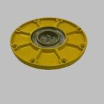 A yellow metal plate with multiple holes and a central fastener.