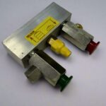 A complete valve assembly with a silver metal body and yellow, red, and green levers.