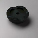 A black cast iron cap with a textured surface.